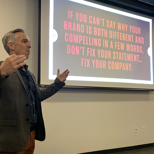 Skot Waldron speaking at a workshop on branding